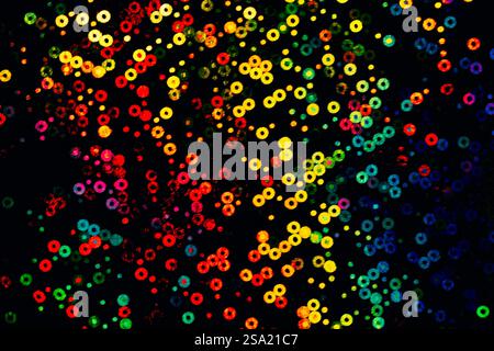 Vibrant Abstract Bokeh Rings, stunning array of multicolored bokeh rings arranged in a dynamic, abstract composition. Stock Photo