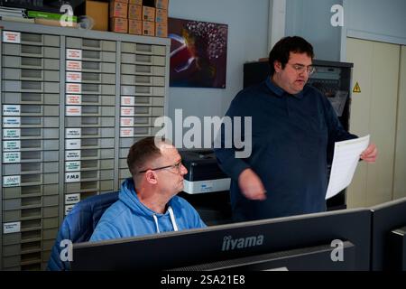 Disabled worker and his monitor working in the printing, reprography and marking workshop. work with disabilities 016794 029 Stock Photo