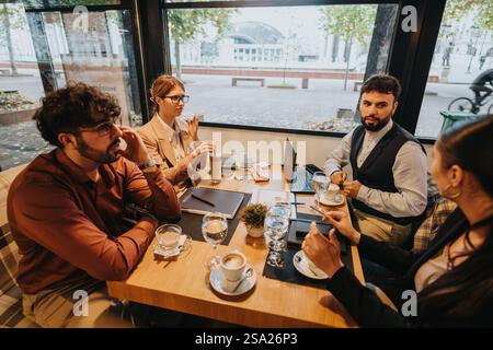 Business people having a collaborative meeting in a modern cafe setting Stock Photo