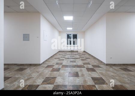 white empty long corridor with red brick walls and doors in interior of modern apartments or office Stock Photo