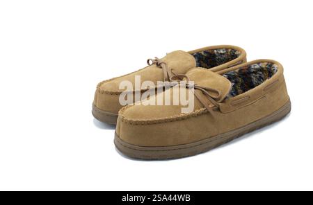 soft brown suede leather house slippers with fuzzy warm plush faux fur lined interior material to add warmth for feet.  Isolated on white background w Stock Photo