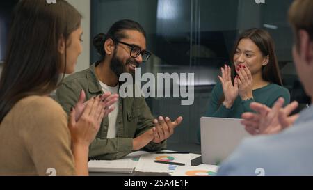 Business team multi ethnic women men group co-workers colleagues young creative managers sit at office conference table share ideas discuss startup Stock Photo