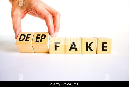 Deepfake or fake symbol. Concept words Fake Deepfake on wooden cubes. Beautiful white table white background. Businessman hand. Business and deepfake Stock Photo