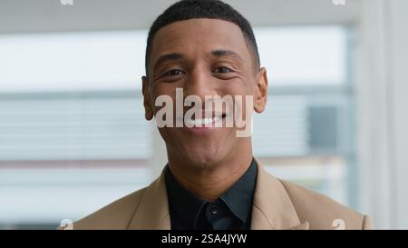 African American man 30s millennial businessman portrait indoors happy joyful cheerful smiling white dental teeth health oral smile dentistry service Stock Photo