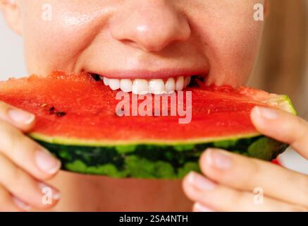 Woman eating watermelon closeup photo. Stock Photo