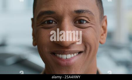 Headshot smiling African American man happy guy ethnic face close up portrait looking at camera satisfied model male businessman customer looking at Stock Photo