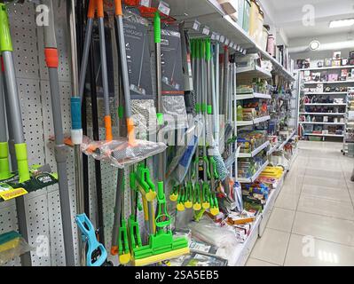 Cleaning supplies aisle in hardware store with various tools and accessories. Stock Photo