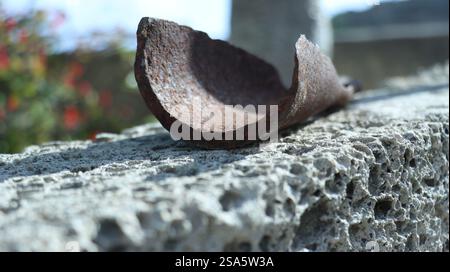 close-up of part of a rusted metal pipe on top of a pumice wall. Tenerife. Stock Photo