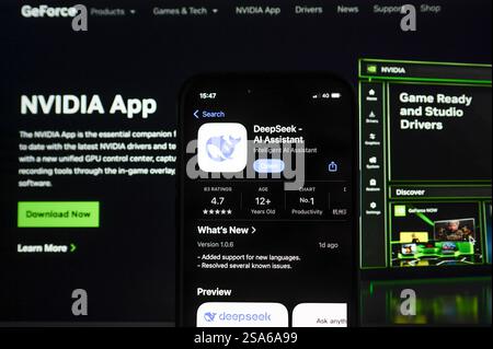 In this photo illustration, the DeepSeek app seen displayed on a mobile screen in front of a computer showing the website of tech company Nvidia whose market value has dropped since the arrival of its Chinese competitor. Tech shares have struggled to regain footing after the release of Chinese AI assistant DeepSeek. Stock Photo