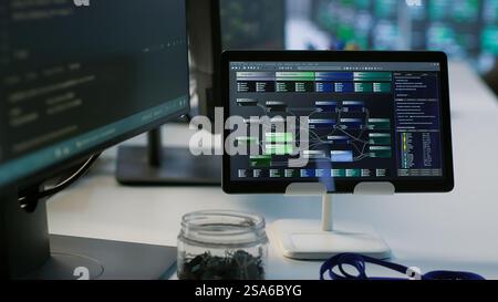 Close up of tablet in data center workspace used for controlling company network infrastructure. Focus on coding software on device in server room used to ensure optimal system performance Stock Photo
