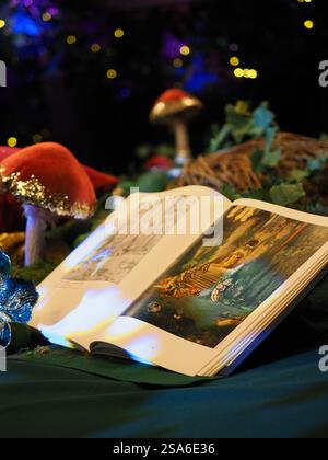 Fairytale book open on a table with toadstools Stock Photo