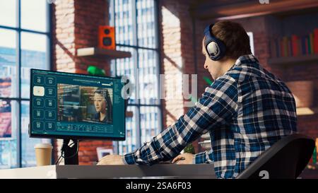 Man listening music while using AI program turning text prompt into videos. Person putting on headphones, interacting with text to video artificial intelligence generative model, camera B Stock Photo