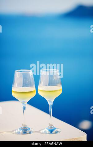 Two glasses of white wine over sea view background Stock Photo