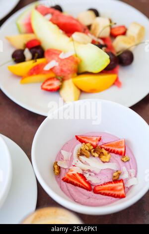 Delicious breakfast with tropical fruits and fresh yoghurt Stock Photo