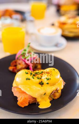 Delicious breakfast with eggs Benedict, vegetables and coffee Stock Photo