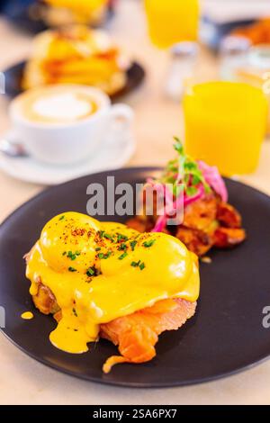 Delicious breakfast with eggs Benedict, vegetables and coffee Stock Photo