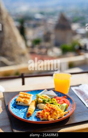 Delicious Turkish breakfast with scrambled eggs served outdoors Stock Photo