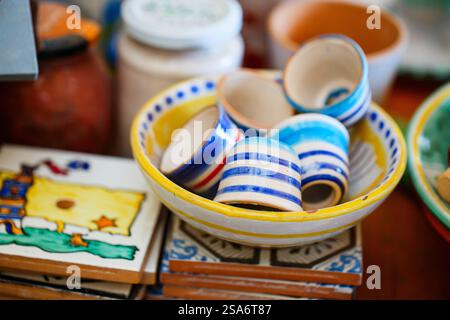 Colorful small dishes and cups in ceramic factory in Italy Stock Photo