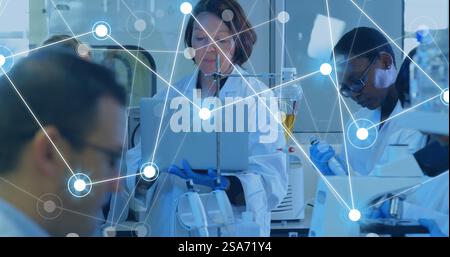 Image of network of connections over diverse scientists working in lab Stock Photo