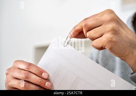 Close up of a man hands putting a paper clip at office Stock Photo