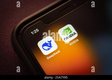 DeepSeek and NVIDIA logos are displayed on an iPhone, representing AI technology and the semiconductor industry. Stock Photo
