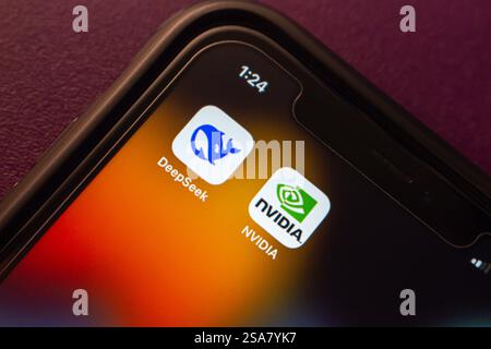 DeepSeek and NVIDIA logos are displayed on an iPhone, representing AI technology and the semiconductor industry. Stock Photo