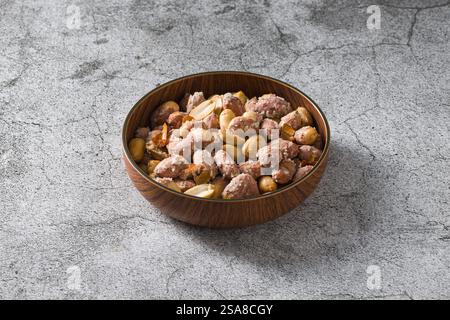 Top view of salted peanuts in wooden bowl Stock Photo