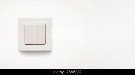 Cream colored wall mounted cream colored double light switch Stock Photo