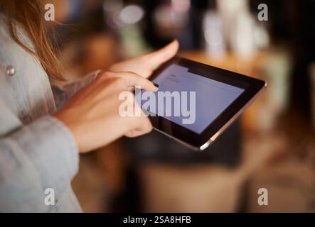 Hands, screen and tablet with store manager in boutique for inventory, online order or stock. Business, management and technology with shop owner Stock Photo
