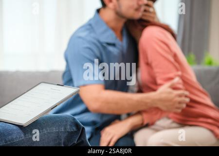 asian couple embraces happily after a productive counseling session with a therapist Stock Photo