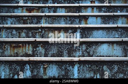Close-up head-on view of part of a rusty metal blue-painted outdoor staircase Stock Photo
