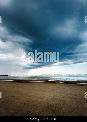 Storm clouds above beach and sea in Norway, dramatic sky thunderstorm weather climate change Stock Photo