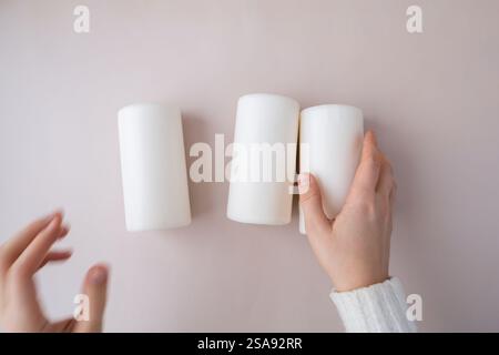 Step by step instruction of making handmade Christmas advent four weeks candle calendar. Female hands creating craft homemade decor. New year celebration. Winter holidays. Do it yourself Stock Photo