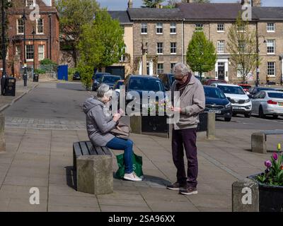 Senior couple both looking at their smartphones, not talking to each other, Bury St Edmunds, Suffolk, UK Stock Photo