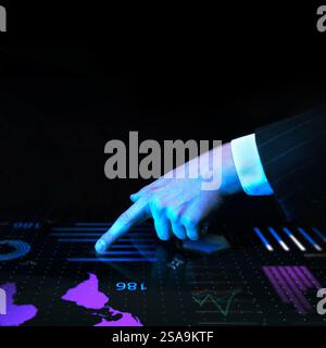 Businessman in dark suit pointing at world map with digital analytics on futuristic interactive screen displaying global data visualization against Stock Photo