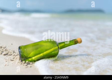 Message in a bottle (MIB) on a sand beach Stock Photo