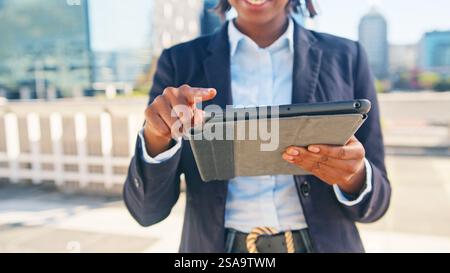 Confident Businesswoman Using Digital Tablet Outdoors in Modern City Stock Photo