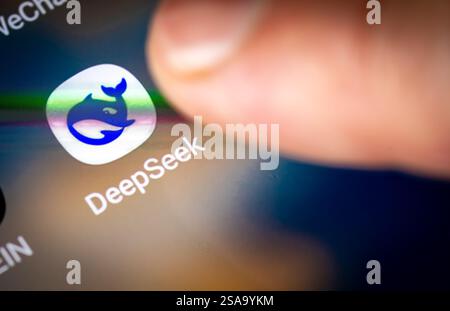 London. UK- 01.29.2025. A person pointing to the icon on a smart phone for the Chinese open source AI app DeepSeek R1. Stock Photo