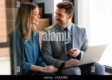 Business professionals collaborating on a project in a modern office. Team of coworkers sharing idea Stock Photo