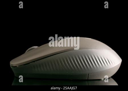 One wireless computer mouse, macro, isolated on a black background. Stock Photo