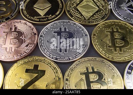 Crypto coins laying flat on black table Bitcoin Ethereum Zcash Litecoin Gold silver bronze. Nice copy space background for your crypto messages Stock Photo