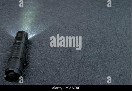Flashlight shining on a black background. Nice copy space. Stock Photo