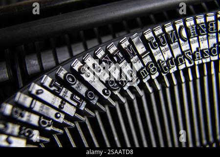 Typebar on a vintage old mechanical typewriter manual. Hammers of an old mechanical typewriter in slow motion close-up. Shallow depth of field. Stock Photo
