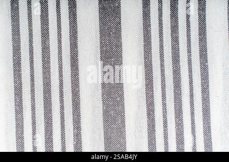 Background with fabric texture of white and gray stripes. A strict and laconic background with vertical stripes of different widths. High quality phot Stock Photo