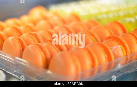 Colorful French macarons on display, showcasing a variety of vibrant flavors and delicate textures, perfect for any special occasion or as a sweet tre Stock Photo