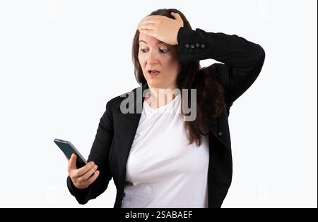 Business woman texting using smartphone over isolated white background stressed with hand on head, shocked with shame and surprise face, angry and fru Stock Photo