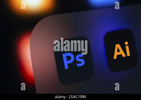 A close up of an iPad screen displaying the Adobe photoshop and adobe illustrator app Stock Photo