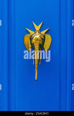 Vintage Brass Door Knocker with Ornate Design on Wooden Door Stock Photo