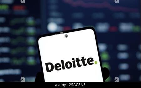 Deloitte logo is displyed on smartphone. Deloitte is a multinational ...