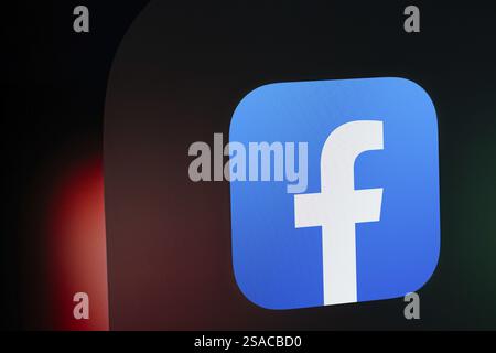 A close up of an iPad screen displaying the facebook app icon Stock Photo